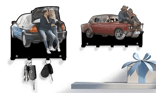 Two personalized key holders: couple in blue-black car trunk, couple on red vintage car hood