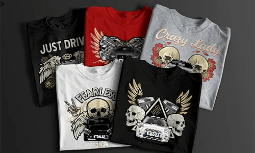Two T-shirts with detailed car front graphics, one red with bold black design and one white with lighter print, placed side by side next to a black gift box with ribbon, automotive-themed apparel for car enthusiasts