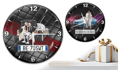 Two wall clocks with family and car scenes: left with trunk picnic on quilted background, right with blue sports car and couple over purple wave