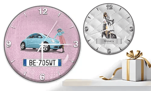 Two wall clocks with female figures and vehicles: left with black car on purple waves, right with red and black cars, racing flags, and blue background