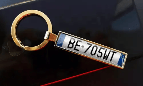 Personalized gold keychain features a custom license plate design