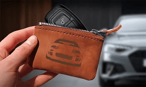 Brown leather key pouch with zipper, printed car and plate 
