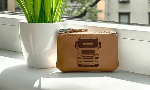 Brown zippered pouch with printed truck front and plate 