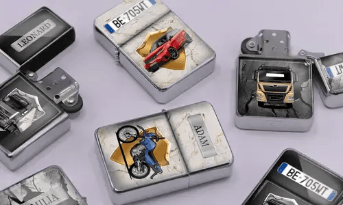 A variety of metal lighters lie on a soft purple surface, featuring personalized designs of cars, motorcycles, and trucks, each marked with different names.