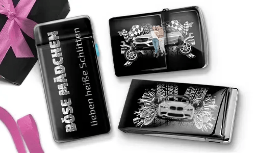 Three shiny black objects with car-themed designs. One reads 