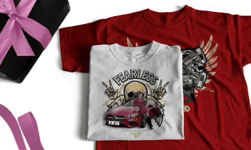 Two T-shirts, one white with FEARLESS, skull, halo, hand signs, red car; one red with winged skull