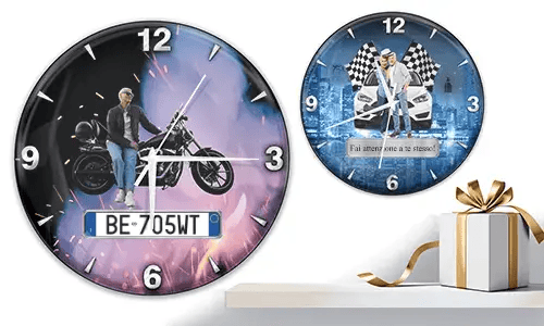 Two wall clocks with vehicle scenes: left with motorcycle and purple-orange glow, right with white cars and racing flags on blue background