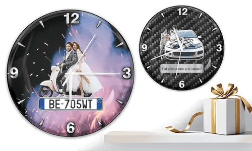 Two wall clocks with romantic vehicle scenes: left with wedding couple on white scooter and fireworks, right with couple and car on carbon background