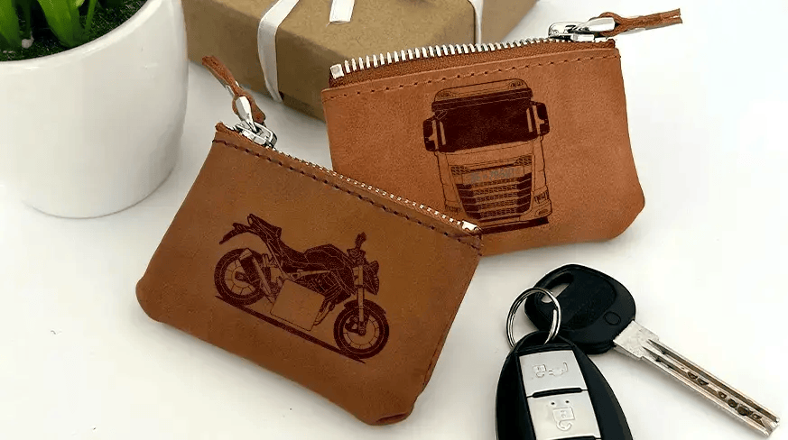 Two brown leather key pouches with zippers: one with motorcycle and plate 